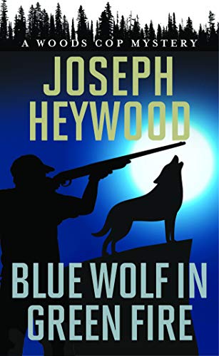 Blue Wolf in Green Fire: A Woods Cop Mystery [Paperback]